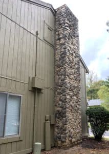 stone chimney leaning away from house