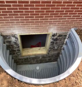 basement window is framed and well is installed