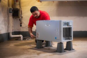 crew member installing dehumidifier