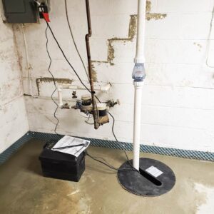 Basement waterproofing including sump pump installation with battery backup