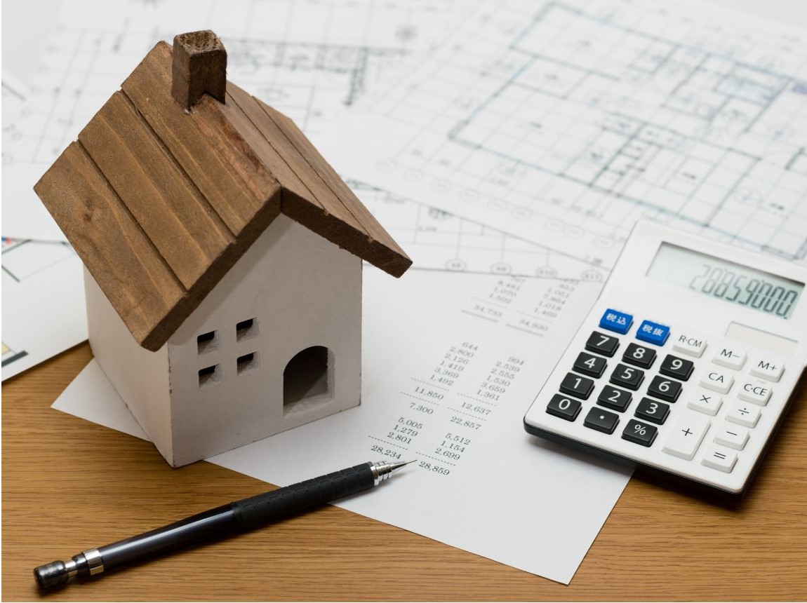 desk with house plans and calculator